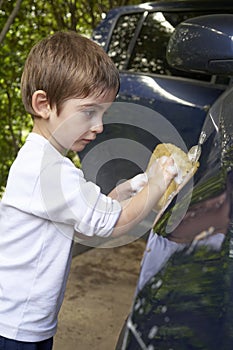 Little boy helping to wash the car. Car Wash