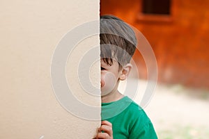 Little boy hide and seek photo