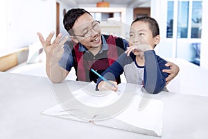 Little boy and his father learn to calculate