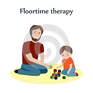 Little boy and a his father sitting on a floor and playing with blocks. Floortime therapy technique, used for teaching