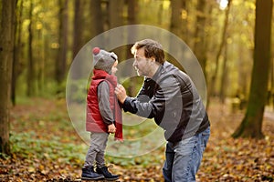 Little boy with his father during stroll in the forest