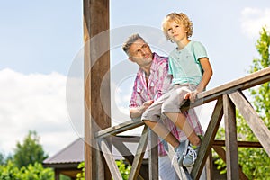 Little boy with his father waiting for mother outside their house