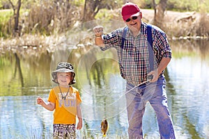 Little Boy and His Grandpa Fishing