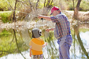 Little Boy and His Grandpa Fishing together