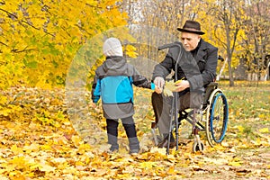 Little boy with his handicapped grandfather