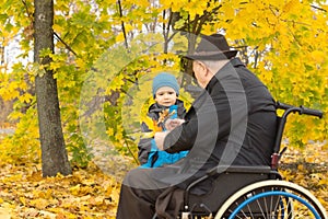 Little boy with his handicapped grandfather
