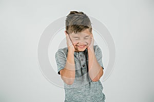 Little boy with his hands covering his ears