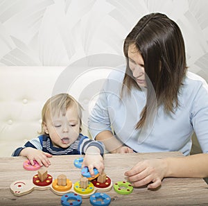 Little boy and his mom play in developing the game