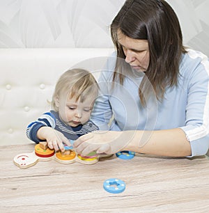 Little boy and his mom play in developing the game