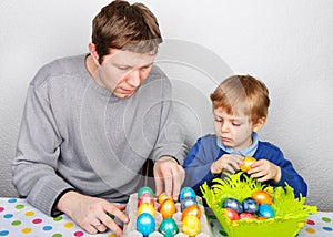 Little boy and his mother being happy about selfmade Easter eggs