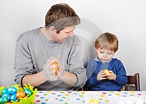 Little boy and his mother being happy about selfmade Easter eggs