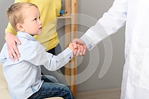 Little boy with his mother at paediatrician on consultation