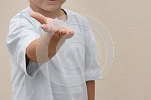Little boy hold and shows grown crystal. Growing crystals is a popular kids craft and fun science experiment.