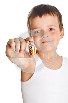 Little boy holding bottle with pollen - isolated