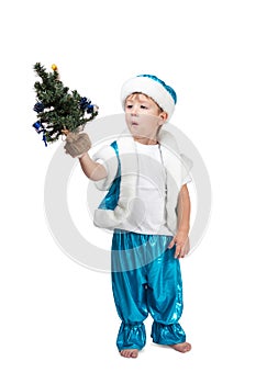 Little boy holding a Christmas tree in his hand