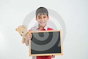 Little boy holding empty blackboard in hand