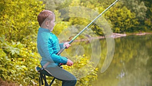 A little boy holding fishing rod and spinning the roulette