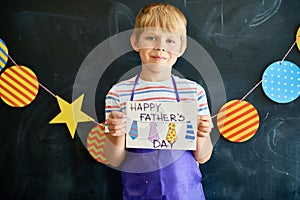 Little Boy Holding Gift Card for Fathers Day