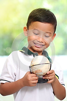 Little boy is holding a globe