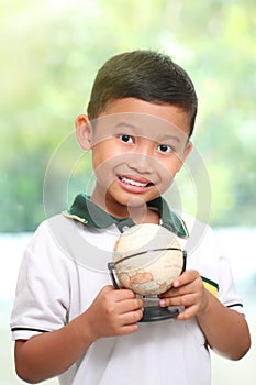 Little boy is holding a globe