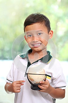 Little boy is holding a globe