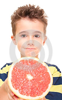 Little boy holding grapefruit