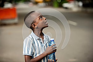 Little boy holding a plastic water bottle