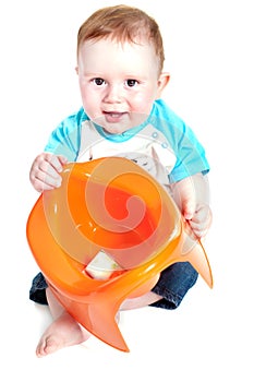 Little boy holding potty