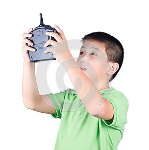 Little boy holding a radio remote control (controlling handset) for helicopter , drone or plane Isolated