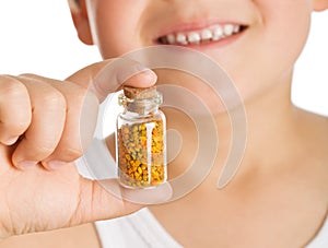 Little boy holding small bottle of pollen