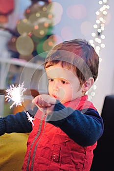 Little boy holding a sparkle stick