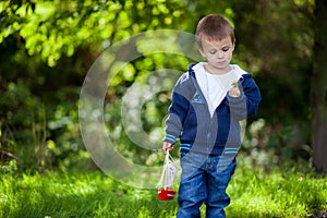 Little boy, holding toy boat