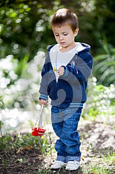 Little boy, holding toy boat