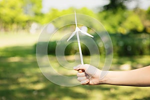 Little boy holding windmill or wind turbine mockup model. Gyre