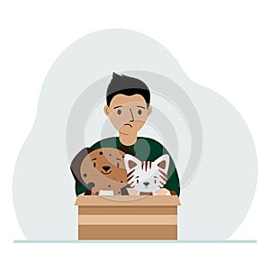 A little boy holds a cardboard box with a cat and a dog. The concept of rescue, help and care for pets.
