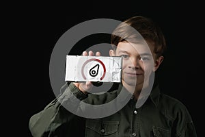 Little boy holds a chocolate bar in foil