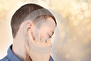 Little boy holds on to the ear, part of the face close-up, medical concept, hearing control, middle ear inflammation, otitis media