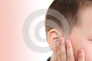 Little boy holds on to the ear, part of the face close-up, medical concept, hearing control, middle ear inflammation, otitis media