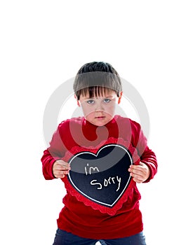 Little boy holds up a i`m sorry sign