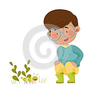 Little Boy Hunkering Down Exploring Worm Crawling on the Ground Vector Illustration