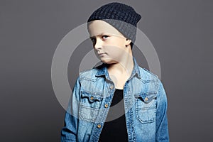 Little boy in jeans and hat. 10 years old kid
