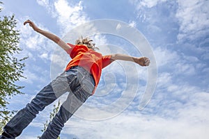 Little boy jumping high into the air