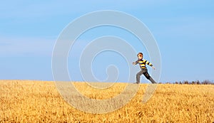 Little boy jumping for joy on a meadow