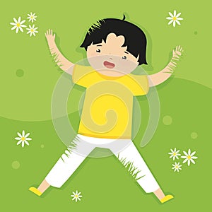 Little boy jumping in the meadow with flowers.