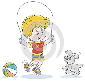 Little boy jumping rope with a small puppy