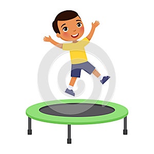 Little boy jumping on trampoline. Happy dark skin sportive child having fun, playing.