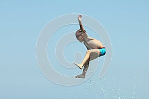 Little boy jumps in sea