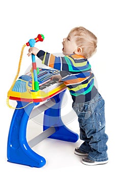 Little boy and the keyboard on white background. funny boy baby.