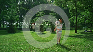 Little boy kicking soccer ball. Focused child practicing in summer park alone.