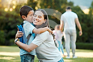 Little boy kissing her mother. Young mother hugging her son. Loving mother hugging son before school outside. Little